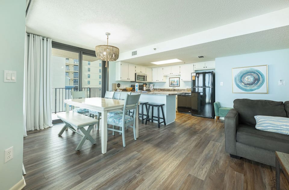 Gather around the dining table, sharing stories and laughter, while enjoying warm coastal sunshine streaming in