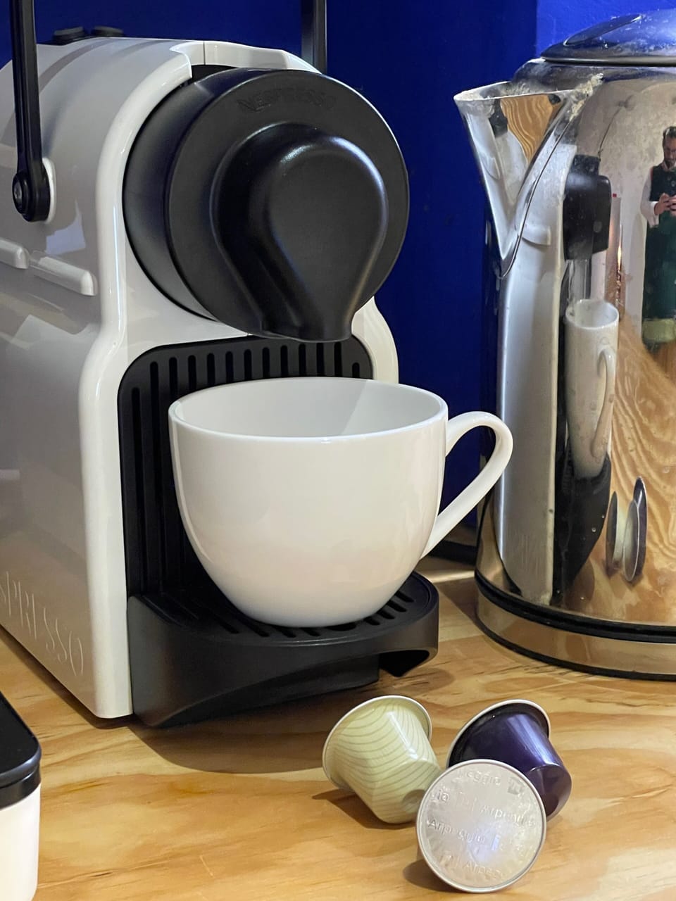 Nespresso coffee maker along with kettle and variety of teas