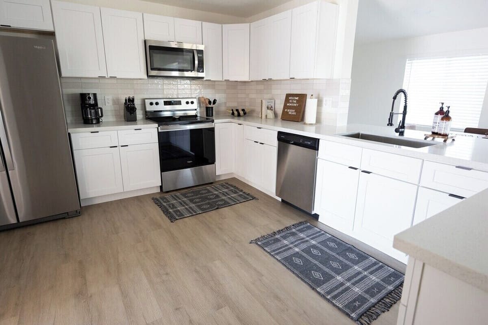 stainless steel appliances in this Gilbert AZ kitchen, Dishwasher, Refrigerator, oven and microwave.  Also coffee maker, knife set, blender, and more. 
