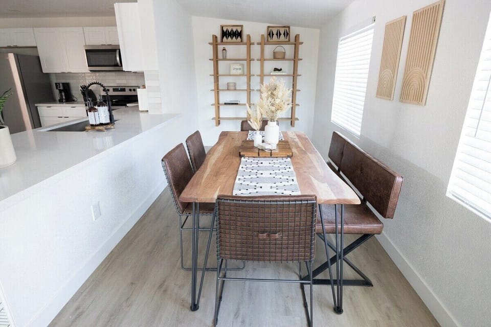 Seating for 6 in this Dining room with an acacia wood table. Even more seating with the large kitchen island just next to it with 3 more seats. Seats 9 total. 