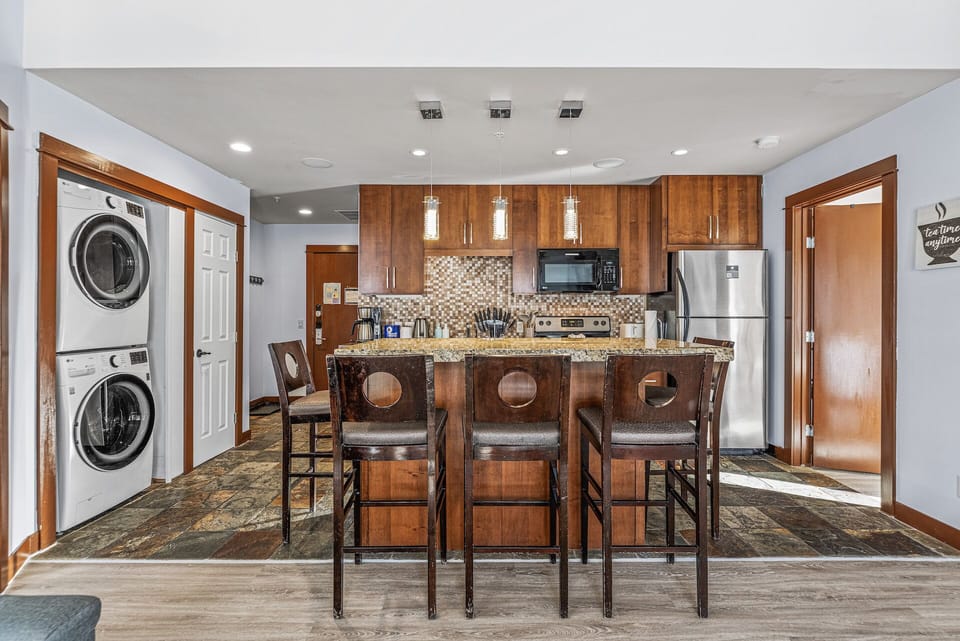 Fully equipped kitchen with basic appliances and blender. 