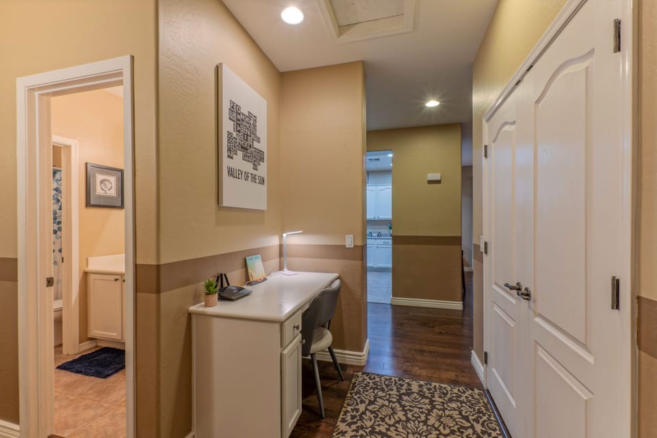 Centrally located desk in bedroom hallway provides another work space for your remote work.