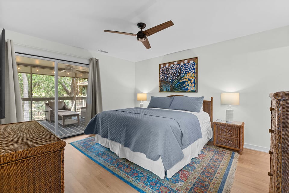 Primary bedroom with king size bed. Sliding door gives acess to the large screened porch