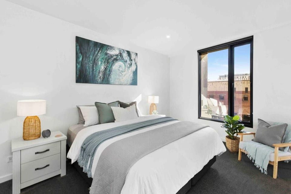 Bright king bedroom with large window and cozy decor