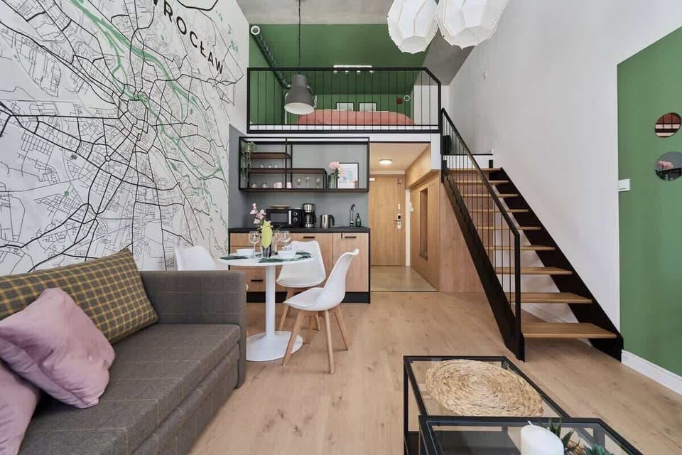A living area with a sofa, coffee table, and decor matching green and white tones.