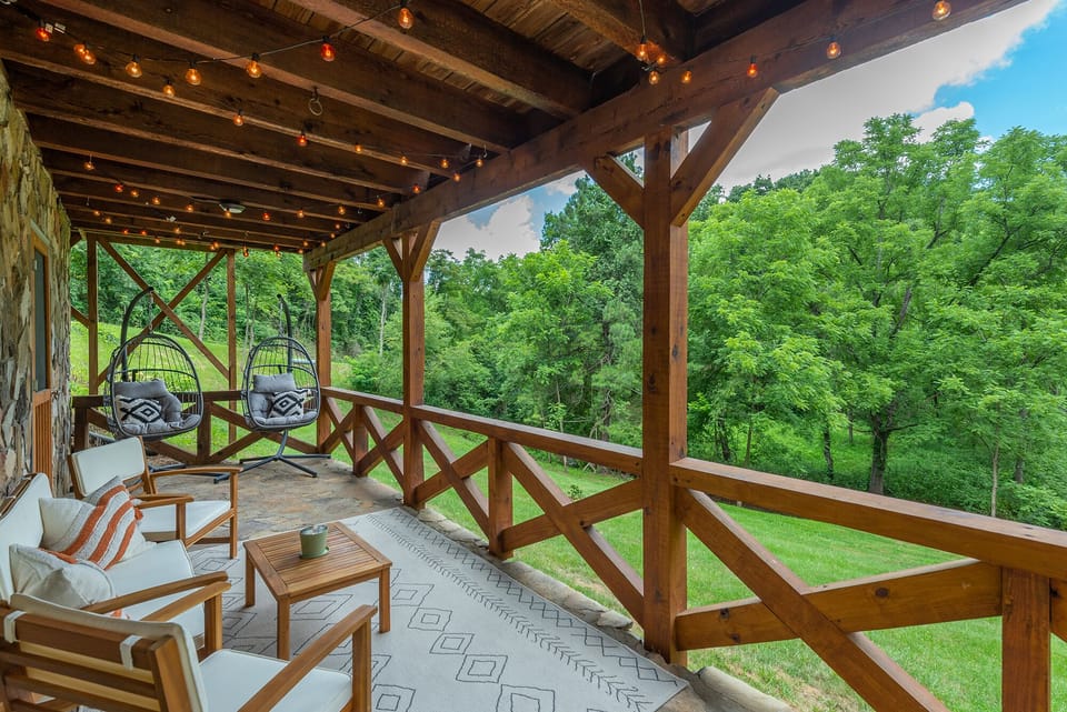 Relax on the bottom deck that overlooks the creek and firepit