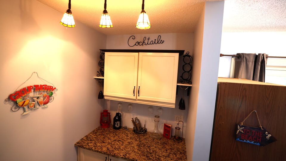 Stocked bar with all you need to make a nice cocktail or enjoy a glass of wine. 