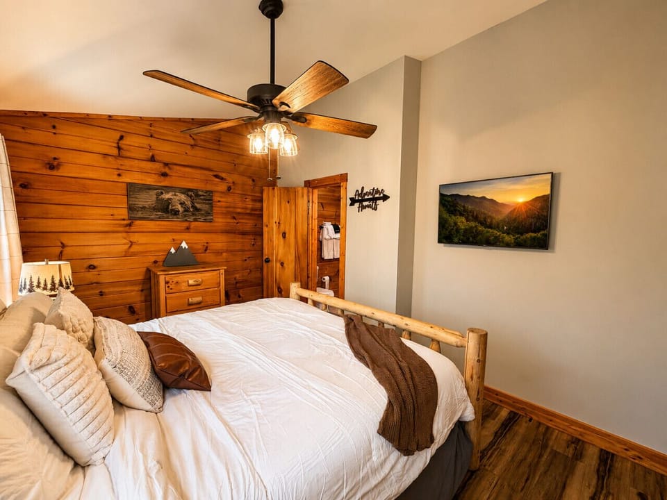 The bedroom has a closet, dresser, smart TV, and is attached to the joint bathroom.