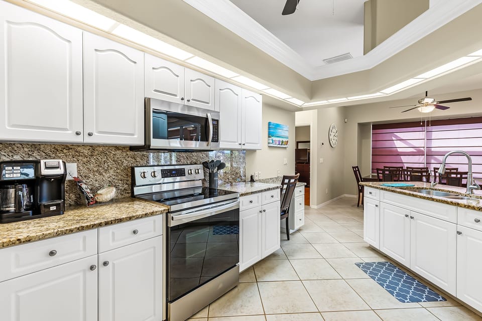 Range area in Kitchen with Desk area/work station on the far right of cabinets