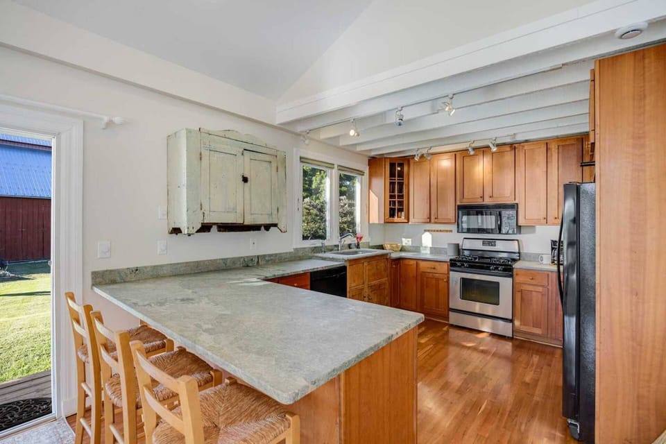 The kitchen has seating for 3 at the breakfast bar.