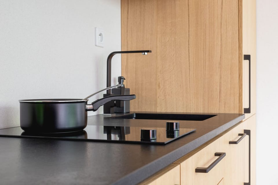 The sleek design of the kitchenette blending seamlessly with the living area.