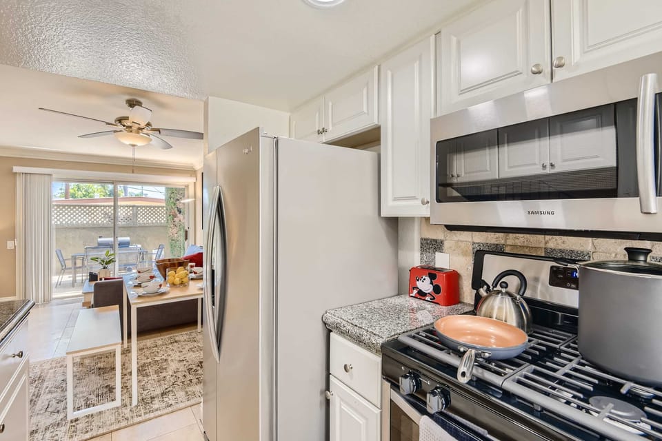 Enjoy the full kitchen with refrigerator, oven, stove, microwave, dishwasher, coffee, creamers, mixers, spices, pots, pans, cooking supplies, cutlery, cups, plates, bowls, utensils, small appliances, and many more essentials.