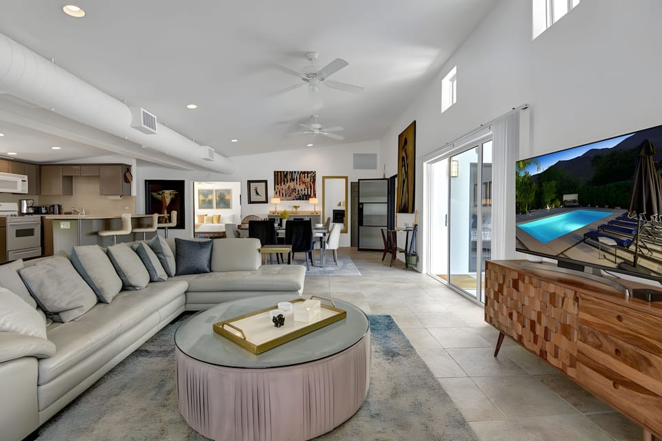 Living room features a large couch and a TV.