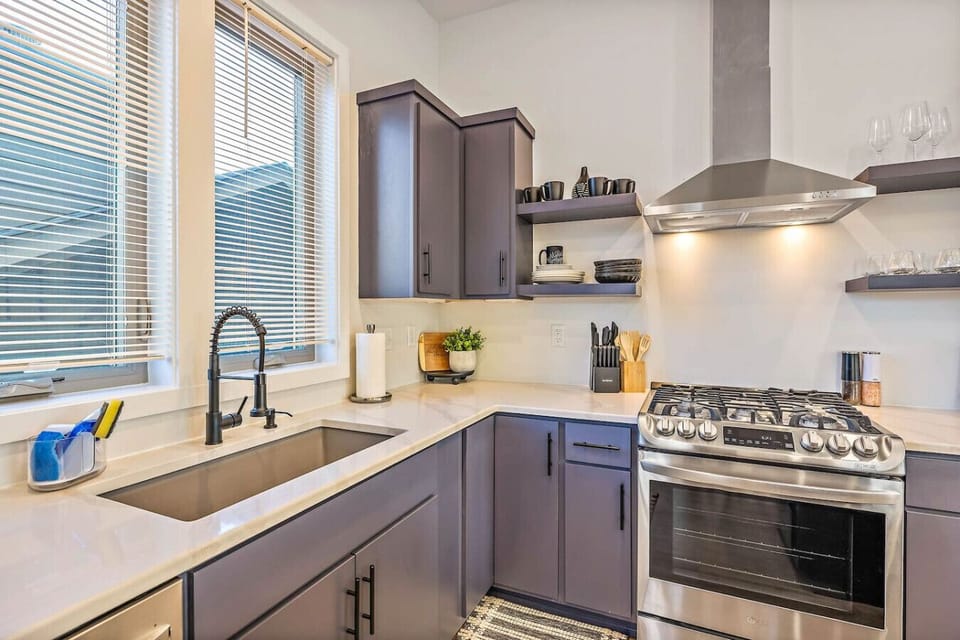 Fully equipped kitchen with dishware and dining seating for 12