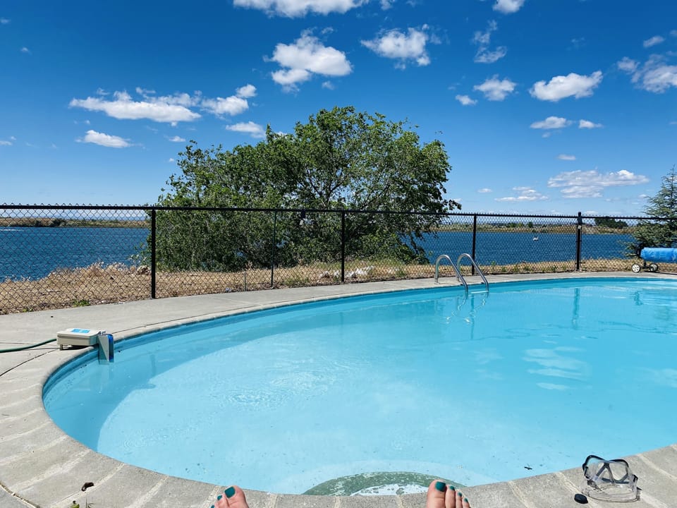 Private pool with a view of lake. 