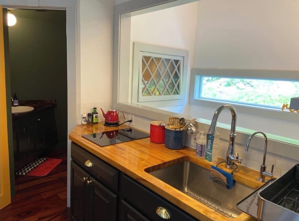Kitchenette with 2-burner electric cooktop, sink, utensils, glasses