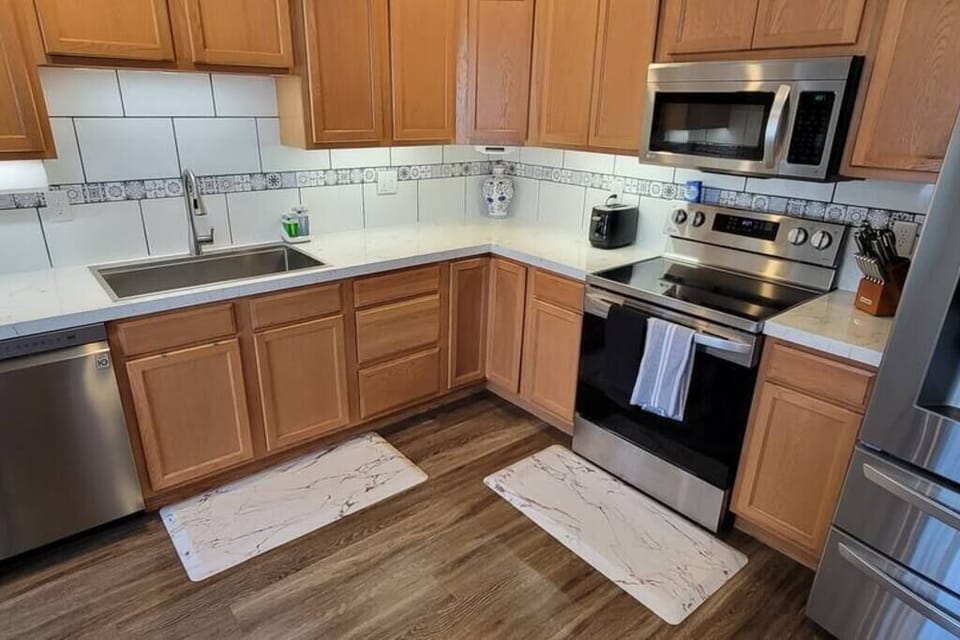 Kitchen with Stainless Steel Appliances, Pots & Pans, Knife Block, and Utensils