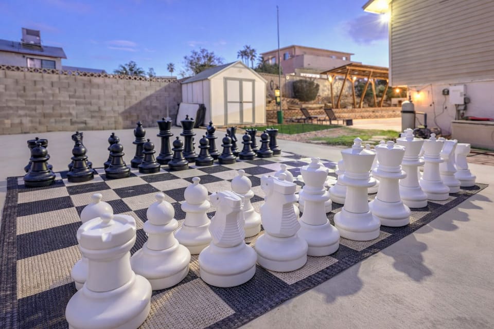 Play giant chess in a private yard with pergola lounge and cozy lighting