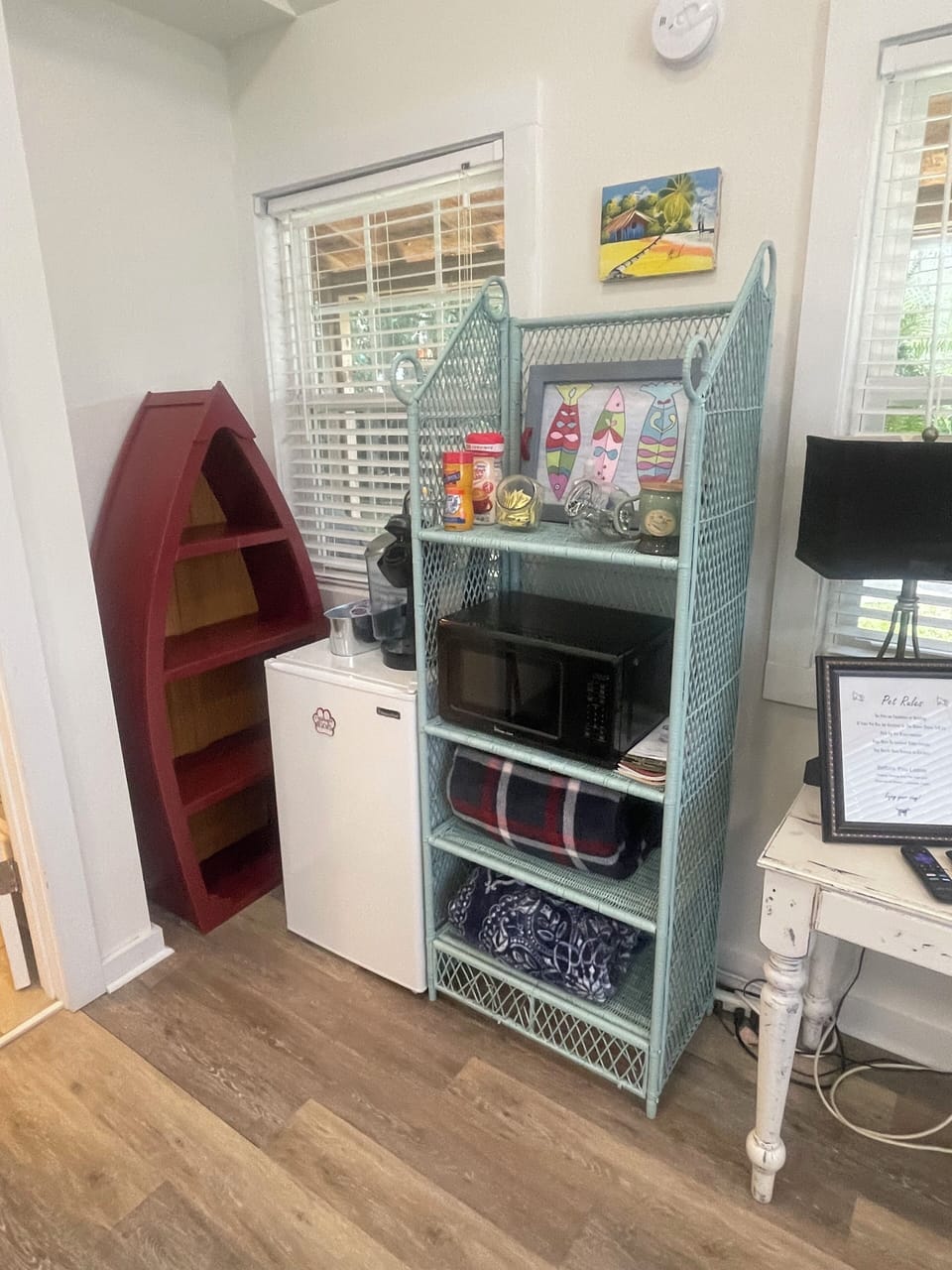 Has refrigerator, microwave, Keurig, and clothes storing on shelves. 