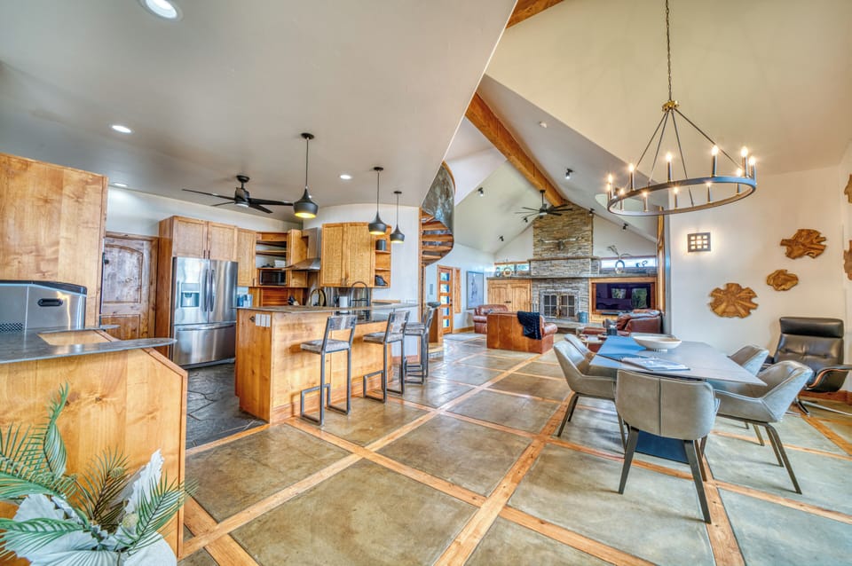 Open-concept living area with gourmet kitchen, dining, and cozy fireplace.