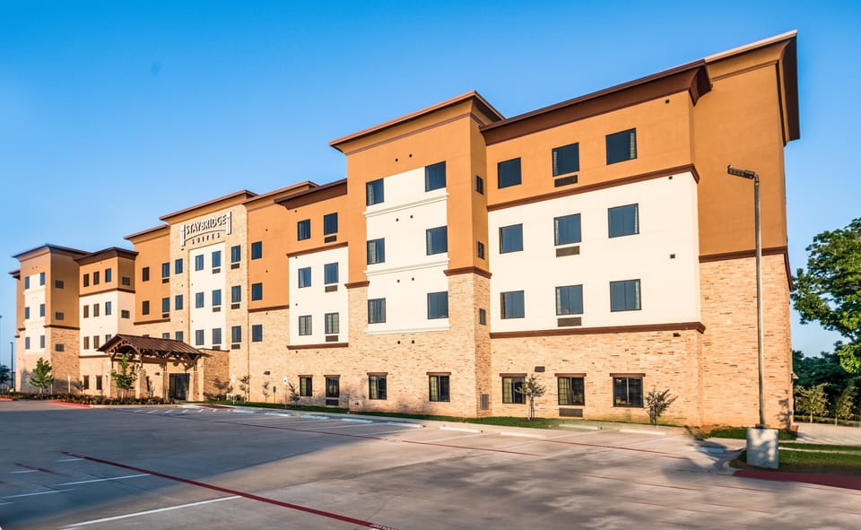 Hotel exterior with modern architecture and entrance signage.