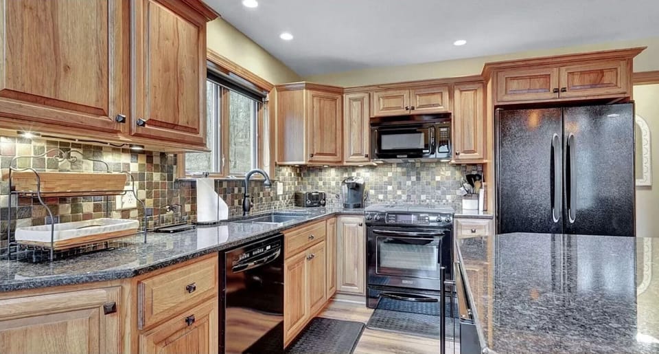 Fully stocked kitchen with granite countertops and coffee bar