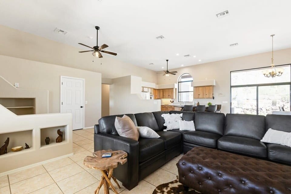 Living room with the kitchen in the background.
