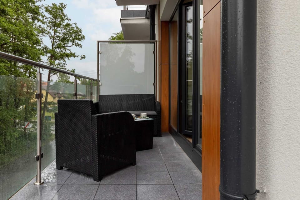 The balcony's stylish design complements the apartment's decor. 