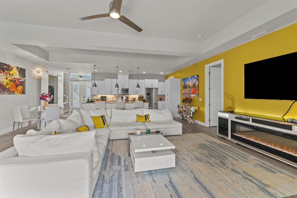Living room with cozy sitting area and large flat screen TV and connected PS4