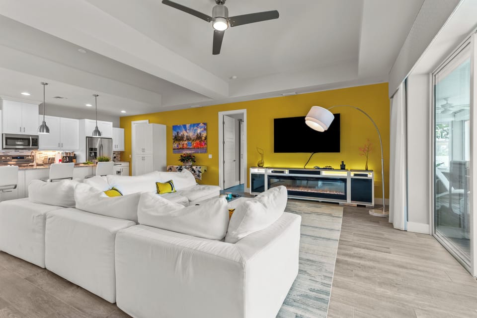 Living room with electric fireplace and large flat screen TV and connected PS4