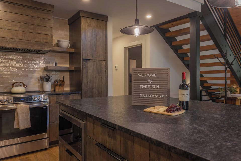 A fully stocked chef's kitchen with a Samsung suite — French-door refrigerator, 36" range, and dishwasher. River Run makes feeding a crew of 14 genuinely enjoyable.