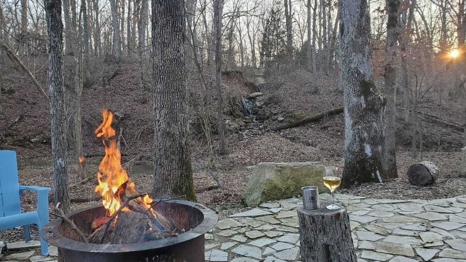 Enjoy the amazing sunset after a rain with the waterfall flowing, a fire & wine