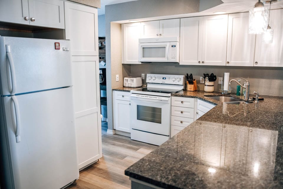 Kitchen is well-stocked with all cooking and dining needs.