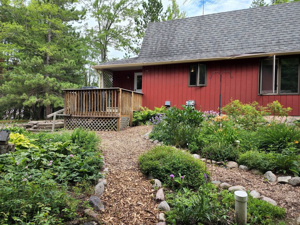 Peaceful perennial gardens surround one side.