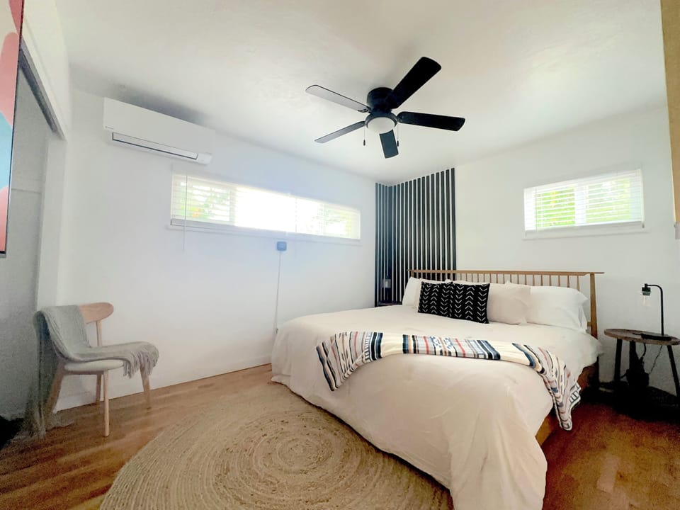 Relaxing retreat featuring a king memory foam bed, accent wall, & dimmable lamps