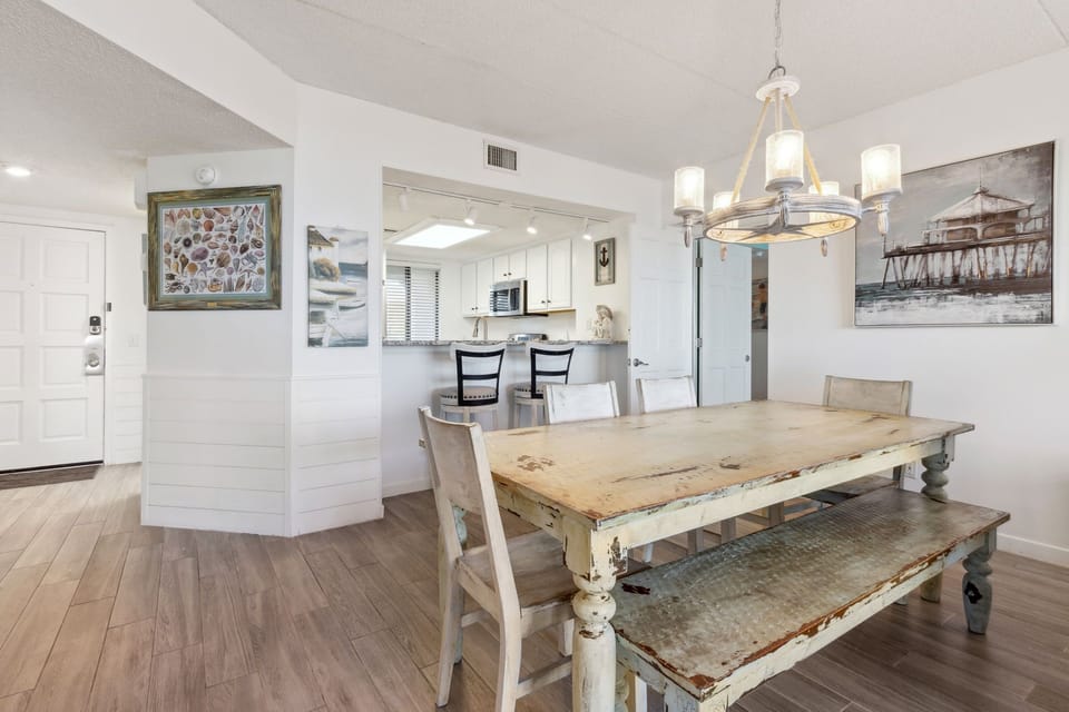Dining Area with Wooden Table Seating Five and Bar Stool Seating for Two