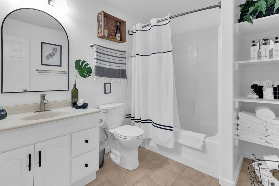 Full bathroom with antique touches. Fresh, bright white, and sparkling clean.