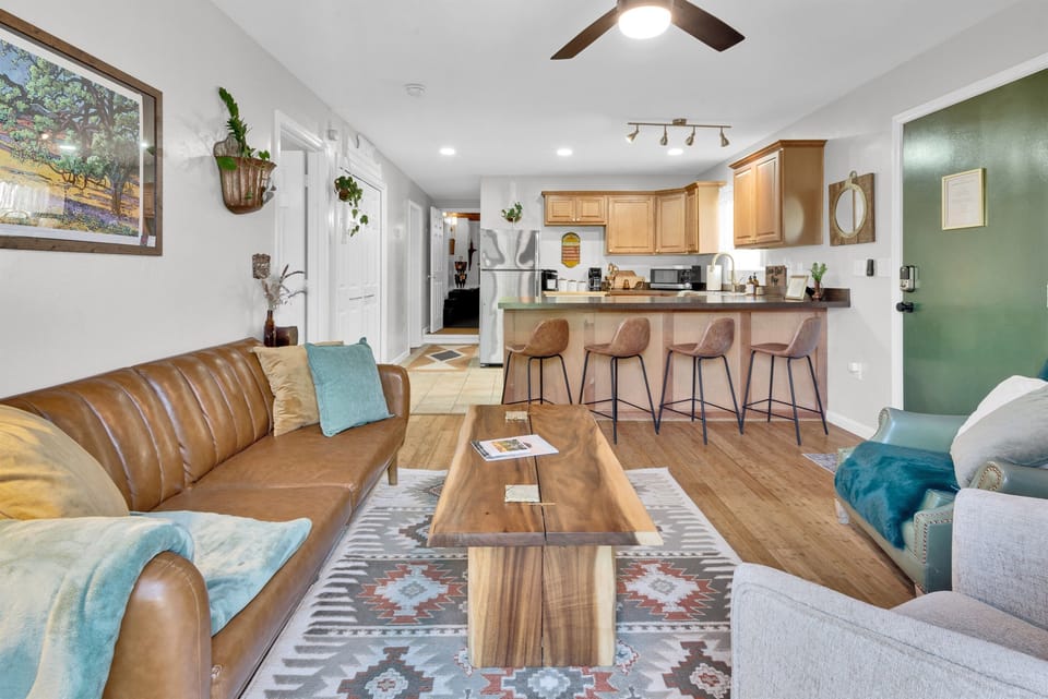 Smart TV, velvet curtains, and metal accents throughout.