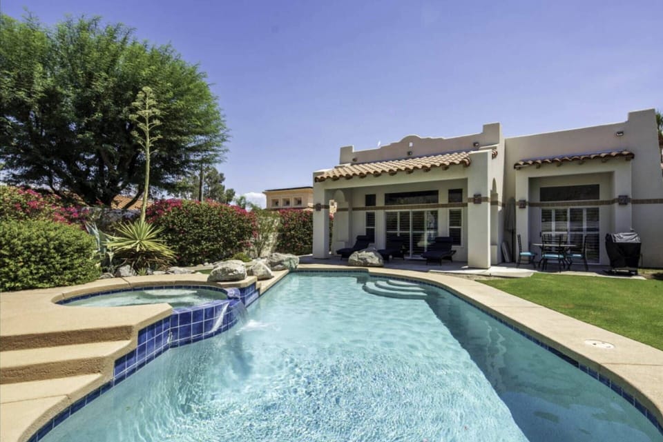 The back of the home with seating and BBQ area