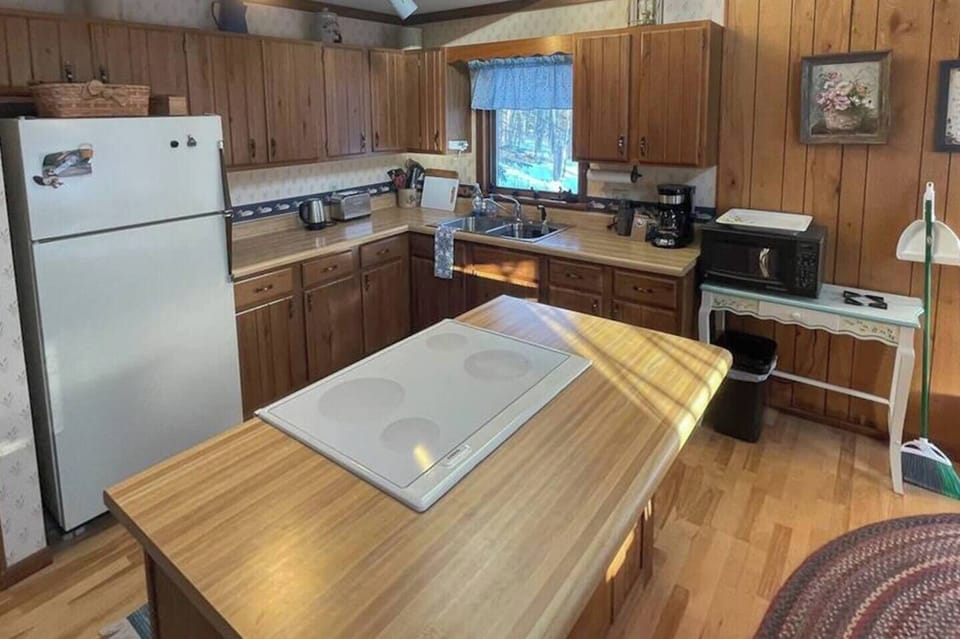 View of the kitchen, which has every appliance and utensil you need to feed the gang. We're also a little proud of our irreverent collection of mugs...