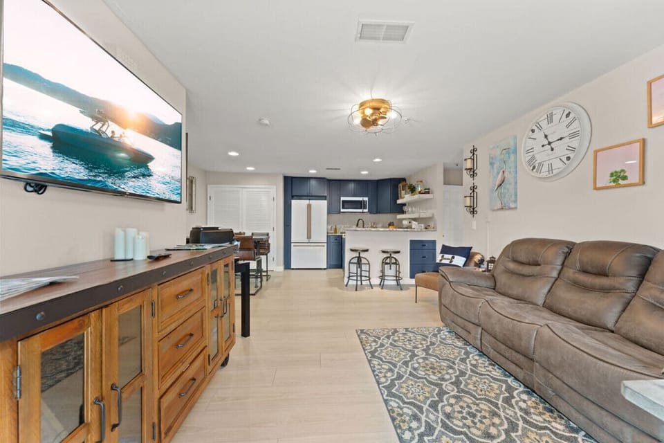 Couch reclines on two ends, games and books in console, huge Smart TV