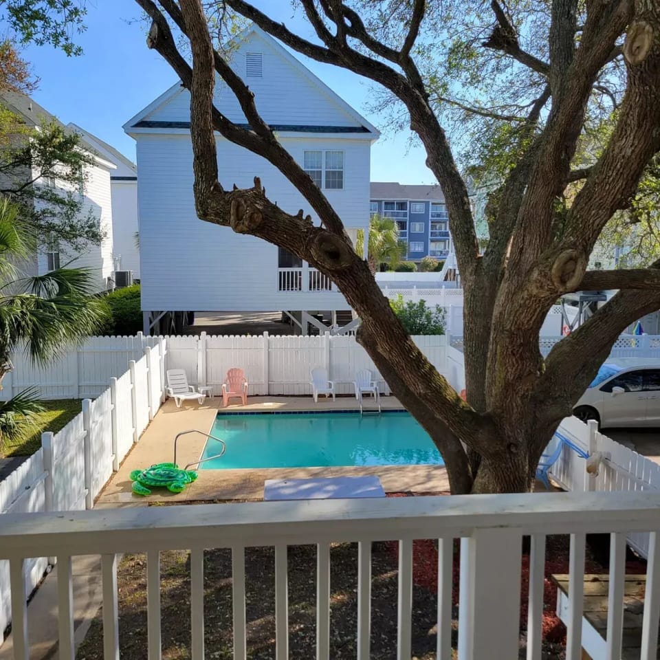 Pool view off Bedroom 1 deck. Tree has been removed.
