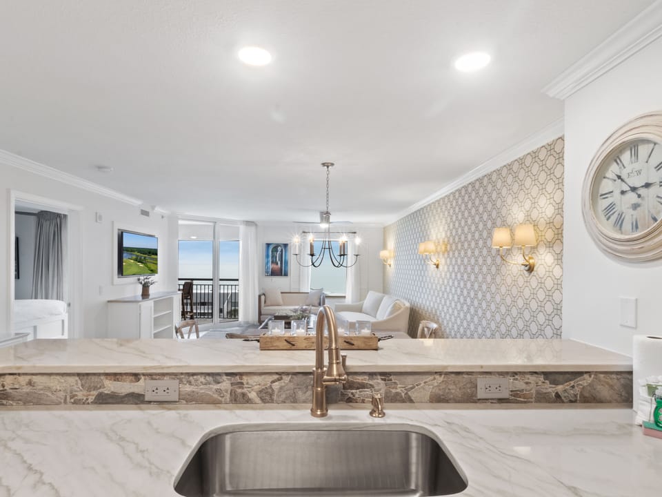Prepare meals at your spacious marble island while enjoying elegant finishes and ocean views beyond.