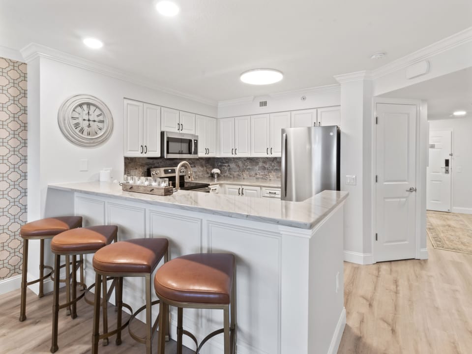 Your fully equipped kitchen features modern appliances and a stylish breakfast bar where you can enjoy morning coffee or casual meals together.