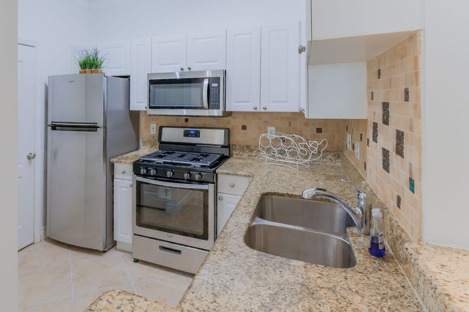 Kitchen includes fridge, stove, oven, microwave, coffee pot, blender, dishwasher