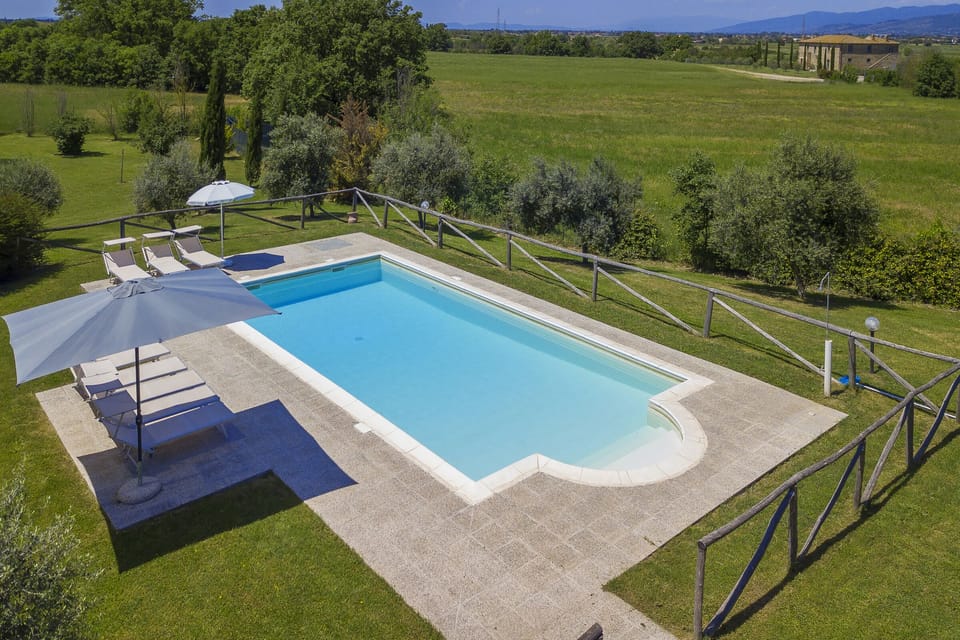 The equipped pool surrounded by greenery