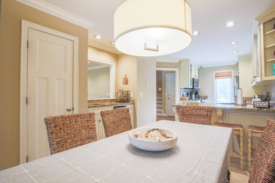 The dining table seats 6 and there are additional stools at the kitchen counter.