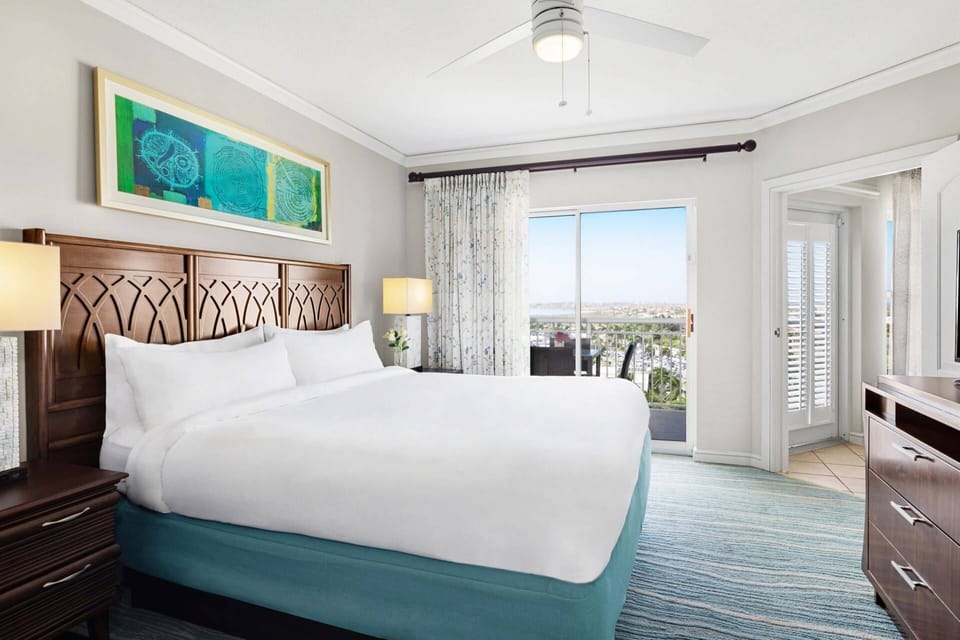 Primary Bedroom features a king bed, door to the private balcony, and an ensuite bathroom (view varies).