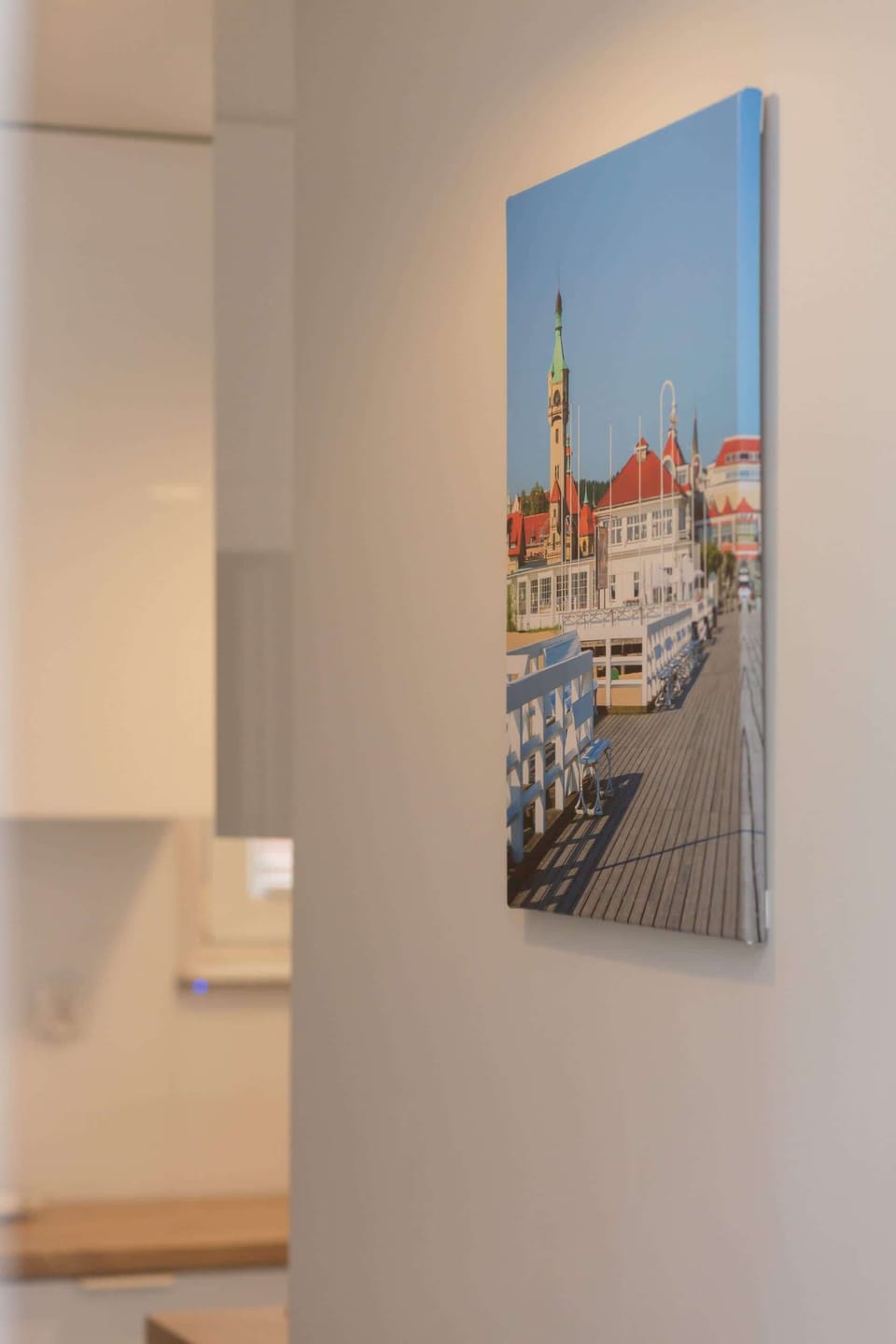 A decorative wall feature with a coastal-themed painting, complementing the room's aesthetic.
