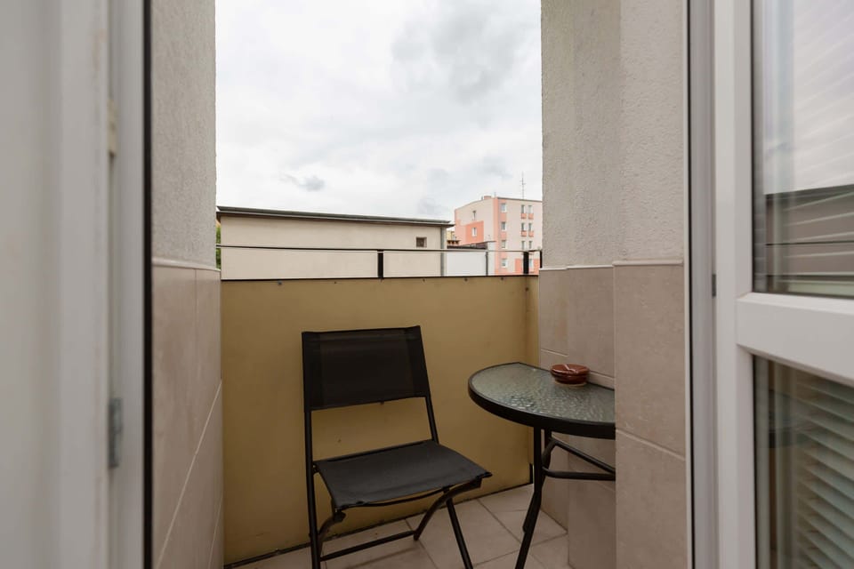 A small balcony with seating, ideal for enjoying fresh air and urban views.
